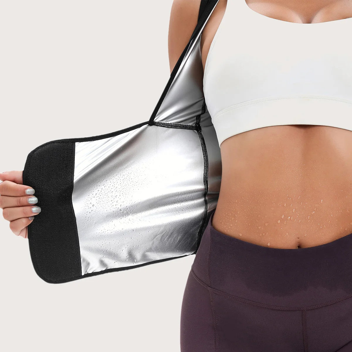 Sweat-enhancing waist trainer vest with a silver metallic thermal lining and black trim, worn over a white sports bra.