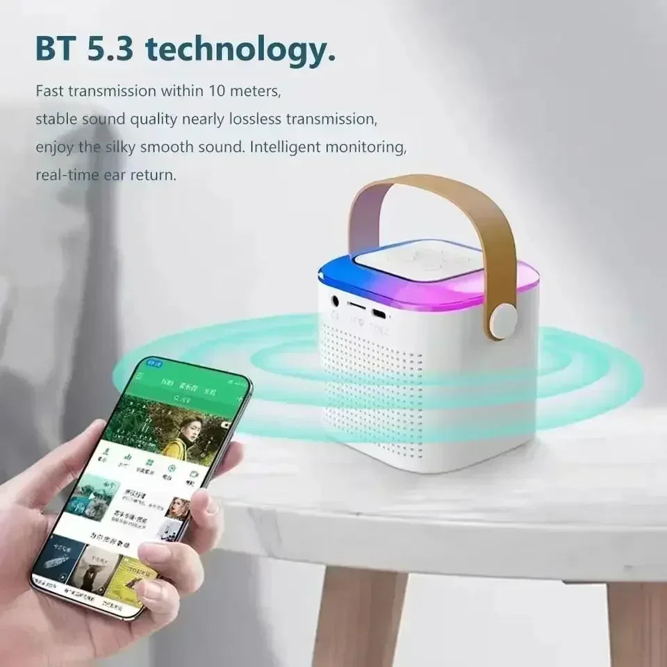 White portable wireless karaoke speaker with a carry handle, glowing RGB top, and smartphone connectivity.