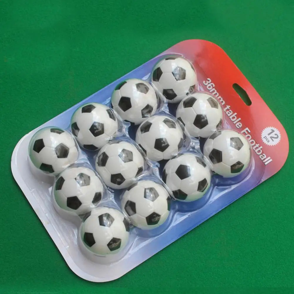 Pack of 12 miniature 36mm black and white footballs for table top games, in clear blister packaging.