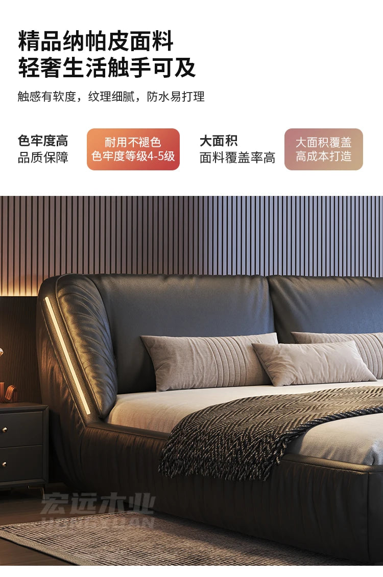 Modern luxury king-size bed frame in black leather-look upholstery, featuring a curved headboard with integrated lighting.