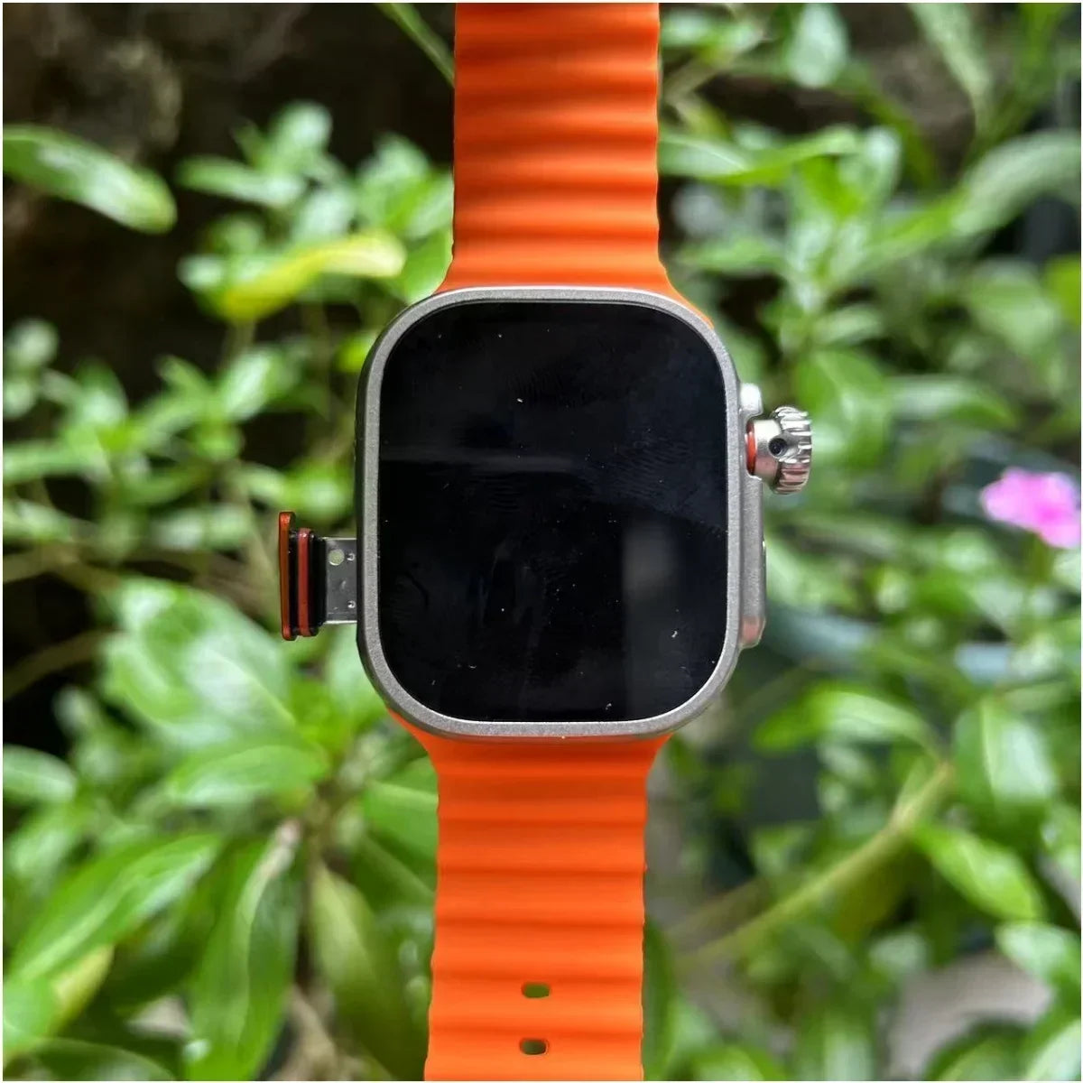 Orange 4G smartwatch with a ribbed silicone strap, silver square case, and an integrated 180° rotary camera.