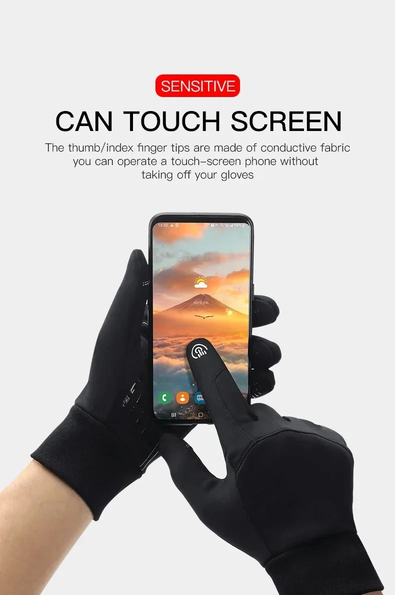 A person wearing black touchscreen-compatible gloves using a smartphone, showing conductive pads on the fingers.