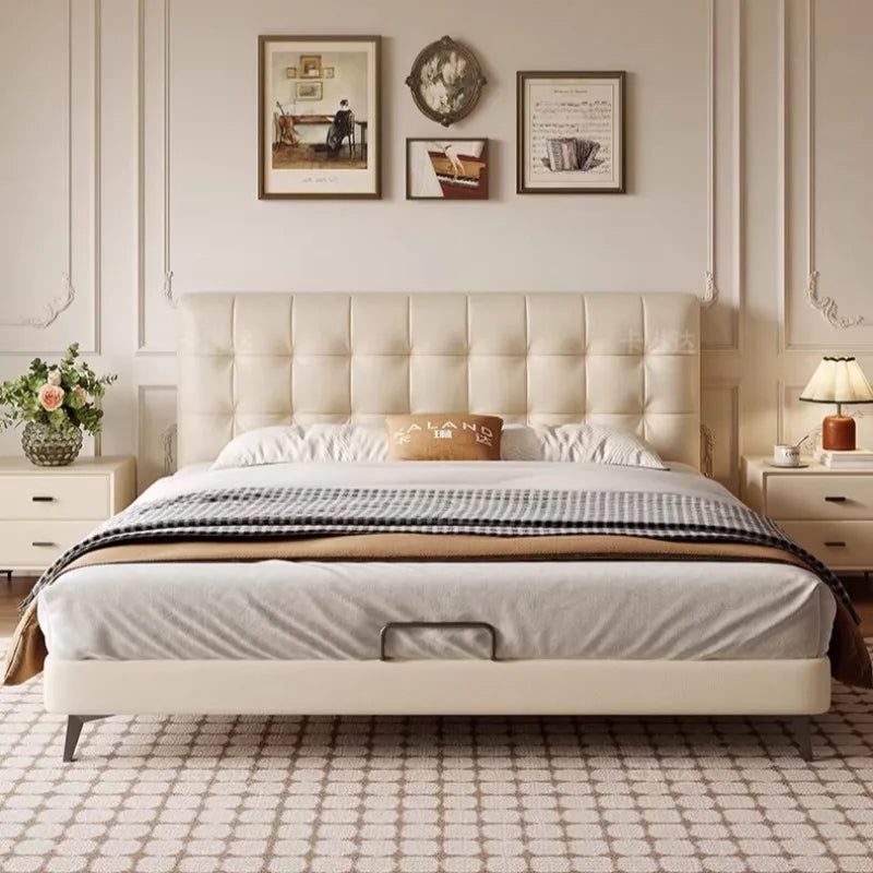 Minimalist cream bed frame with a button-tufted headboard and sleek metal legs, shown in a cosy bedroom setting.