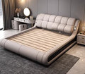 Modern light grey genuine leather bed frame with a curved, tufted headboard and low-profile design.