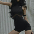 Black sleeveless tight shorts jumpsuit with sheer mesh midriff splicing and a small white chest logo.
