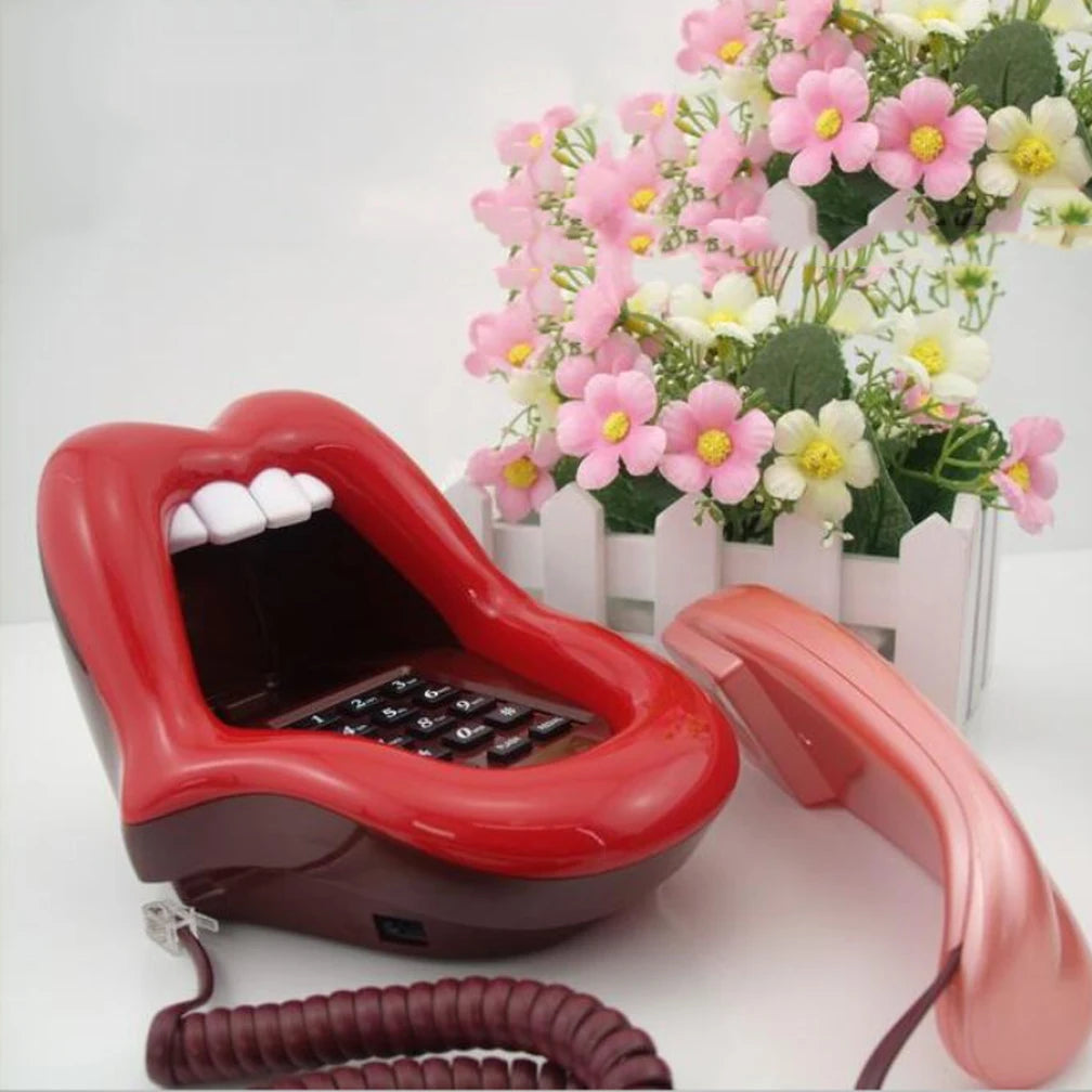 Novelty red lips-shaped corded landline telephone with keypad inside and a matching red handset.