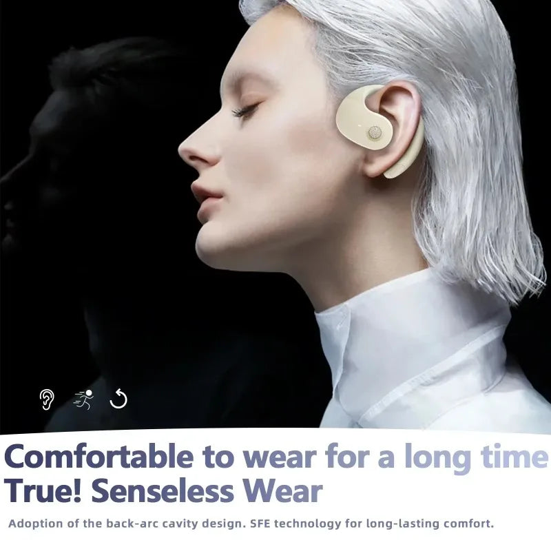 Beige, ergonomic open-ear hook style wireless earbud worn on the side of a person's head.