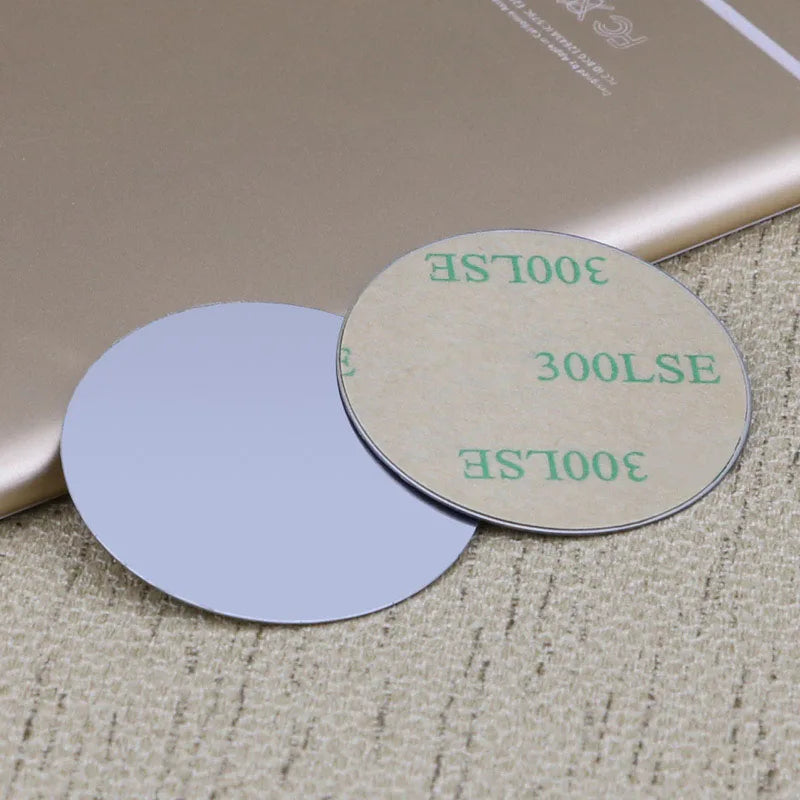 Two circular adhesive discs with beige backing paper labeled "300LSE," shown next to a smartphone.