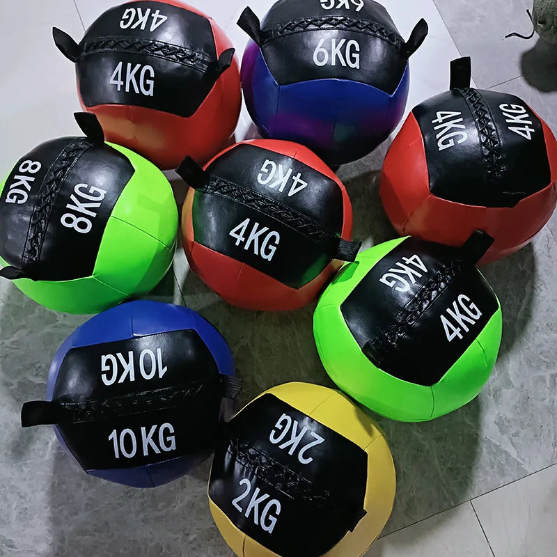 Eight colorful wall balls with weight markings (2kg, 4kg, 6kg, 8kg, 10kg) arranged on the floor.