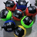 Eight colorful wall balls with weight markings (2kg, 4kg, 6kg, 8kg, 10kg) arranged on the floor.