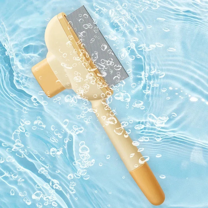Cream-coloured pet grooming brush with fine metal teeth, floating against a blue water background with bubbles.