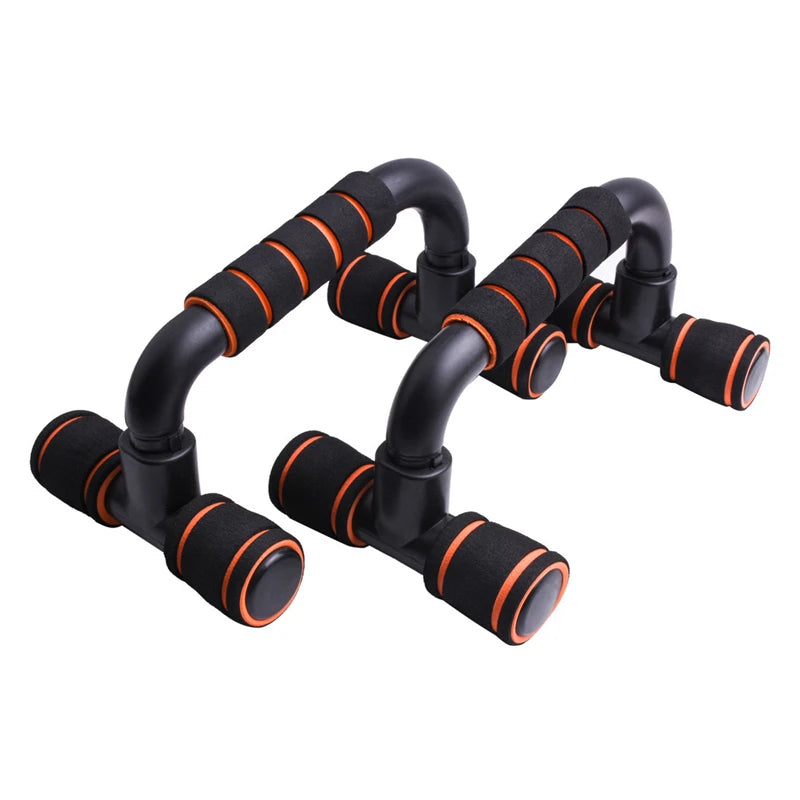 Pair of black and orange push-up bars with foam-padded handles, isolated on a white background.