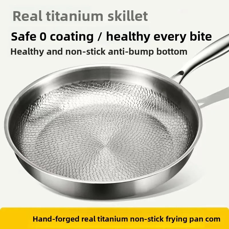 A silver frying pan with a textured, hammered interior and a long handle against a light gray background.