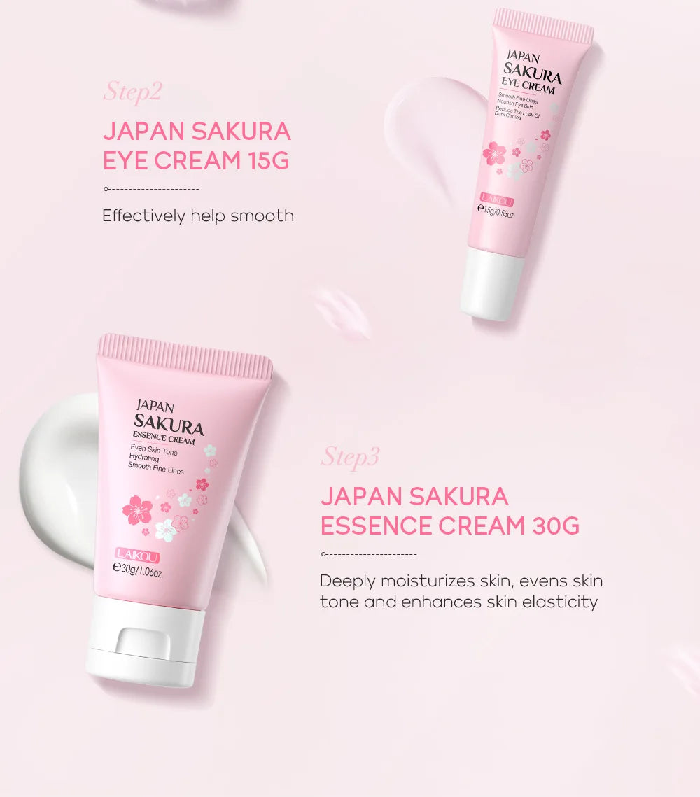 Two pink tubes of sakura eye and essence cream on a light pink background with swatches of white facial cream.