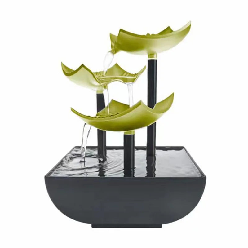 Modern tabletop water fountain with three lime-green, leaf-shaped tiers cascading into a square black base.
