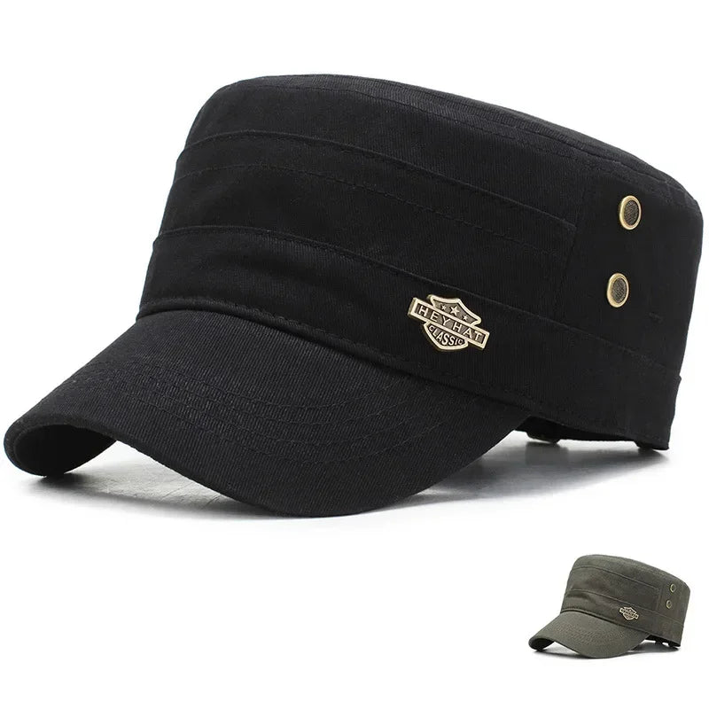 Black cotton military-style cadet cap with a flat top, short peak, side eyelets and a decorative metal badge.