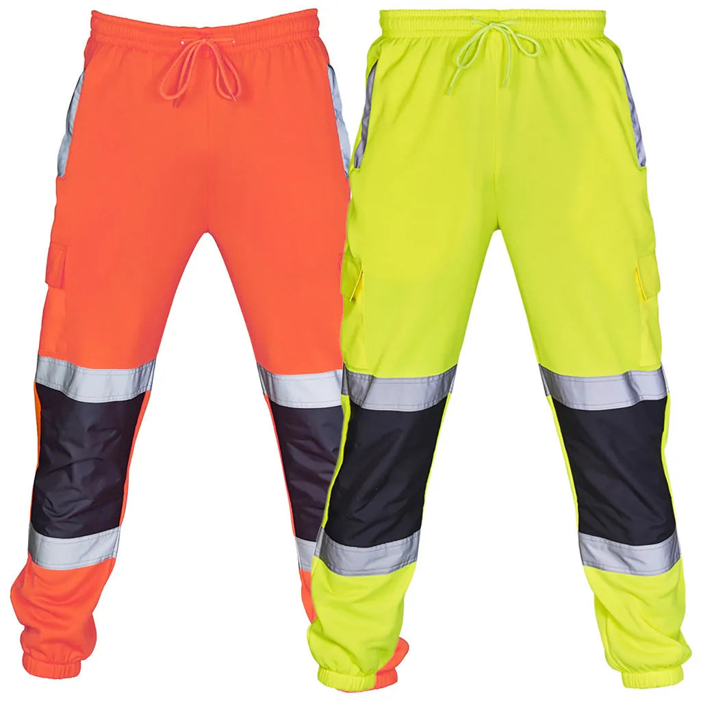Orange and yellow high-visibility work trousers with reflective bands, black knee panels, and an elasticated waist.
