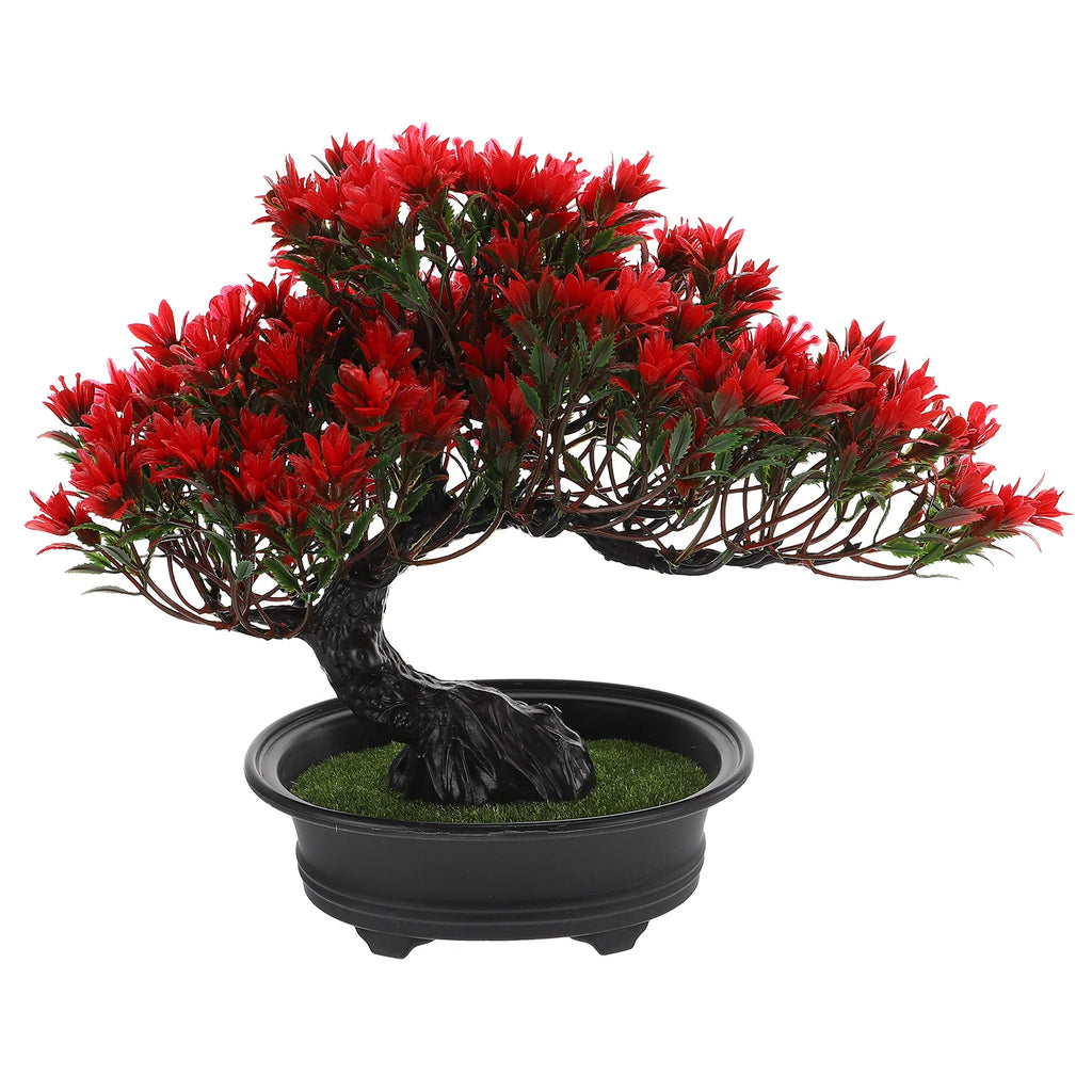 Artificial bonsai tree in a black pot with a twisted dark trunk and vibrant red plastic flowers and green leaves.