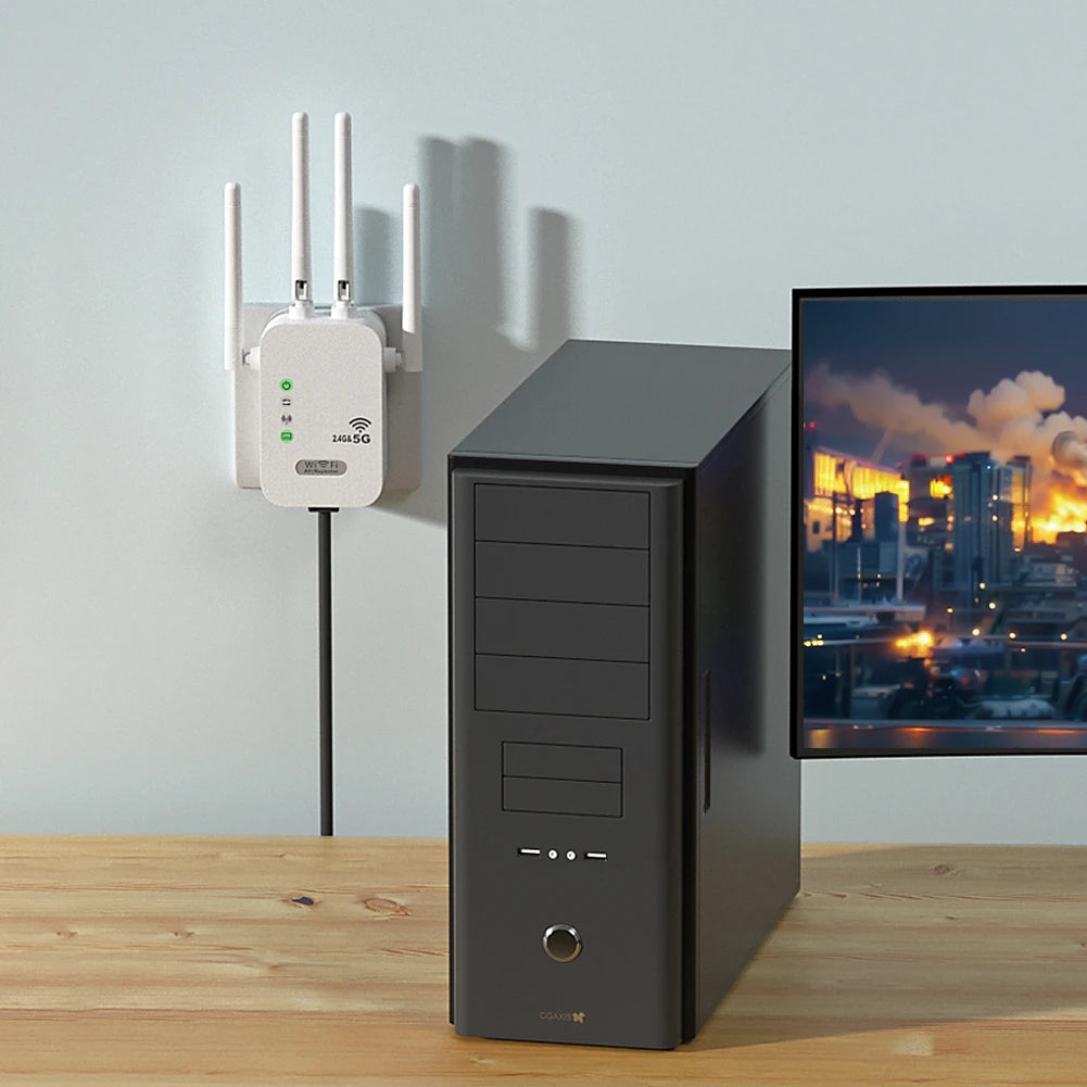 White 1200Mbps WiFi repeater with four antennas plugged into a wall next to a desktop PC and monitor.