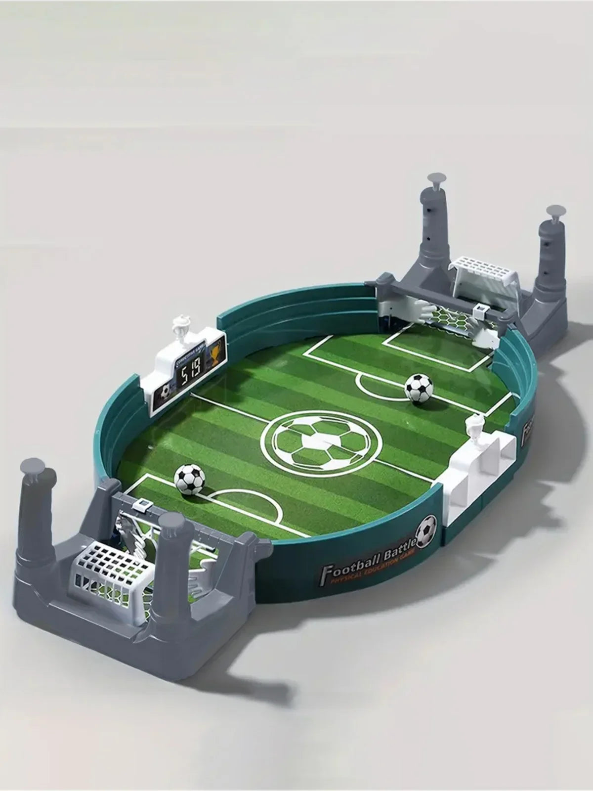 Tabletop football game with green pitch, two goals, digital scoreboard, and two miniature footballs on grey stand.
