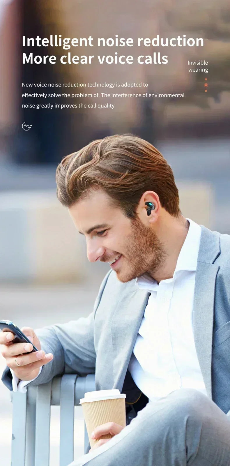 A man in a suit wearing a small, discreet black wireless earbud while using his phone.