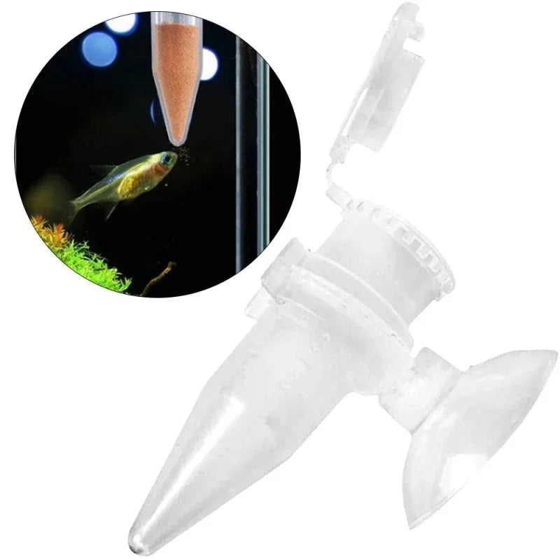 Clear plastic aquarium fish feeder cone with suction cup and hinged lid, shown dispensing food to a small fish.