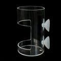 Clear cylindrical wall-mounted holder with two suction cups on a black background.