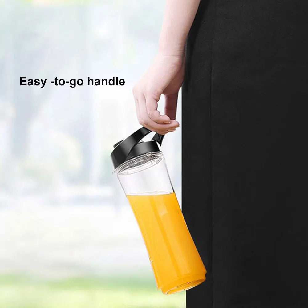 Clear water bottle with black lid and carry handle, filled with orange juice, held by a person.