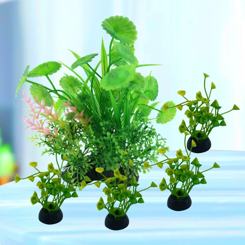 Five artificial aquarium plants with green leaves and pink accents, set in small black weighted bases.