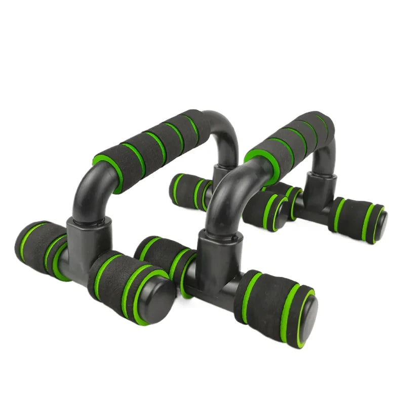 Pair of black push-up bars with green foam-padded handles, isolated on a white background.