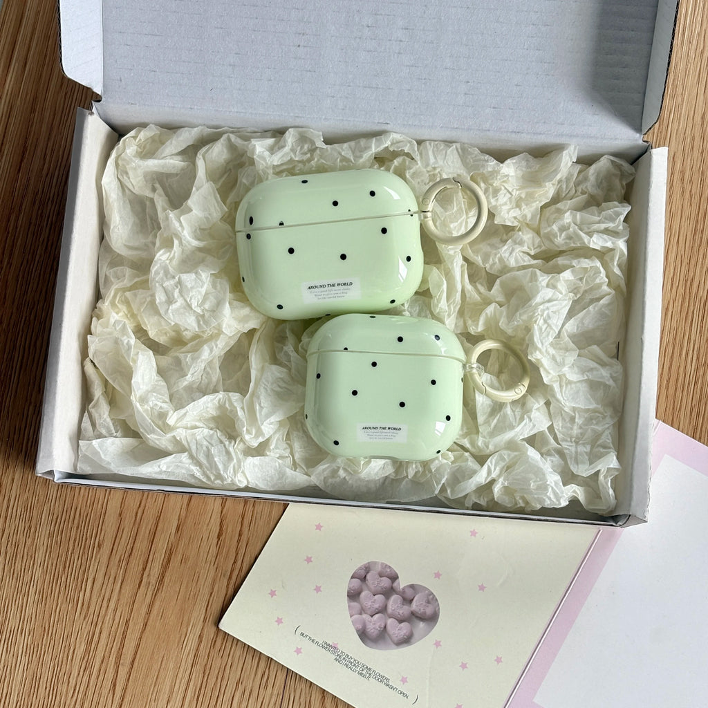 Pastel green polka-dot AirPods Pro and standard cases in a gift box with a keychain loop.