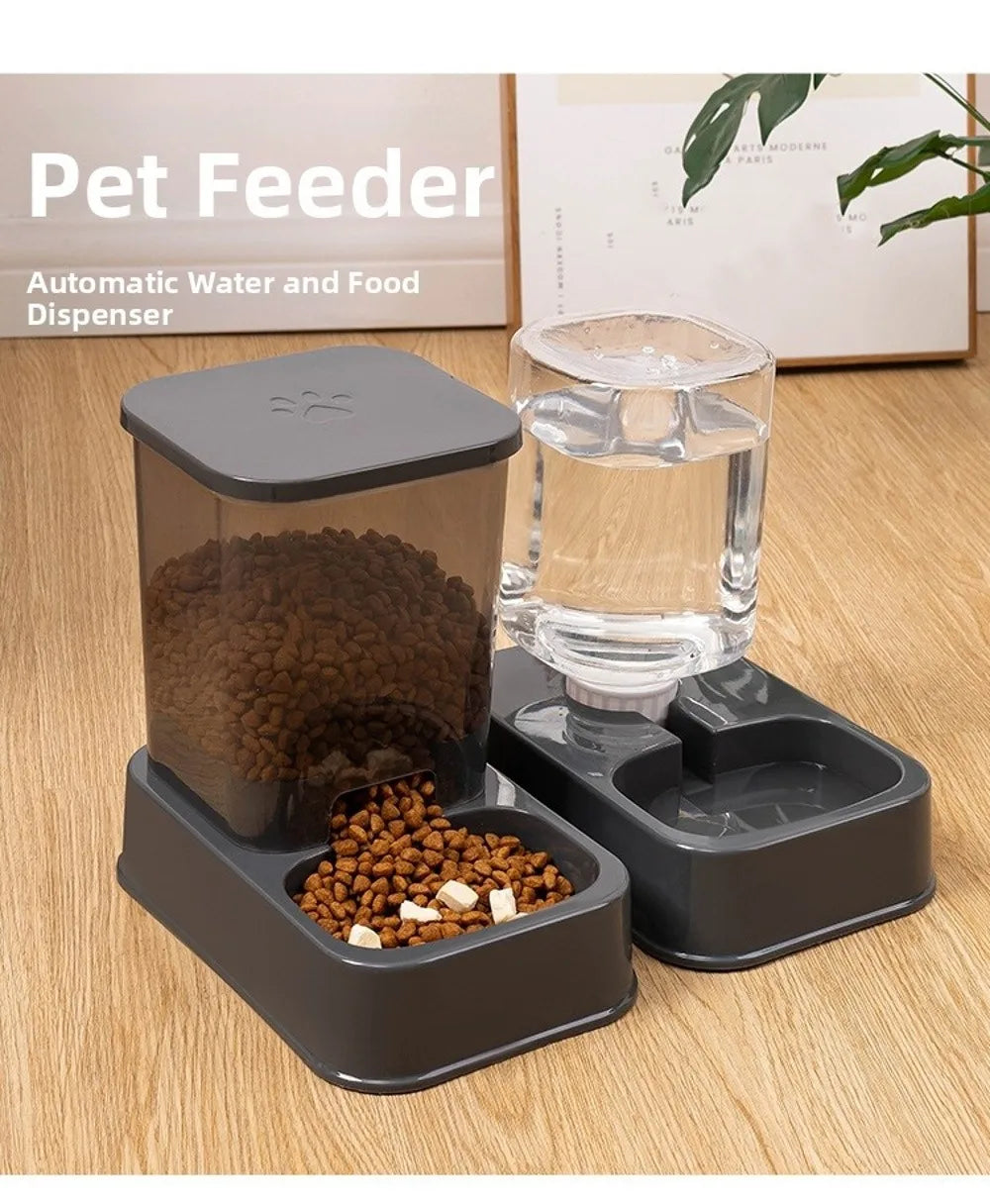 Gray automatic pet feeder and water dispenser set with a clear food container and water bottle on a wooden floor.