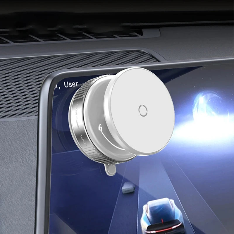 White circular magnetic car phone mount attached to the corner of a vehicle infotainment screen.