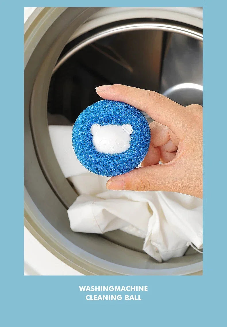 A hand holds a blue textured laundry cleaning ball with a white panda face in the centre, in front of a washing machine.