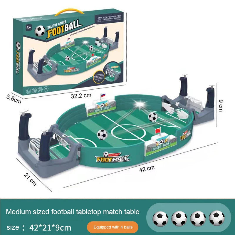 Tabletop football game with green pitch, two goals, manual controllers, and four mini balls. 42x21x9cm.
