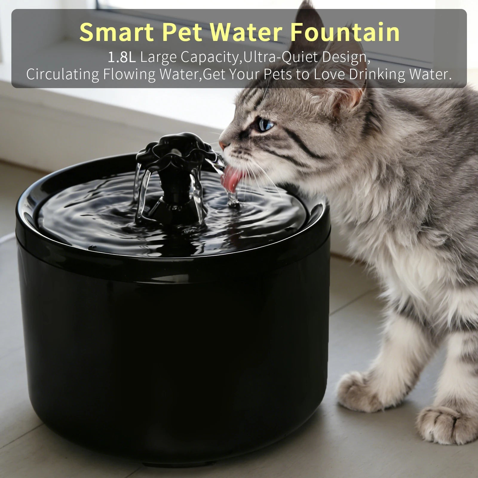A sleek, black automatic pet water fountain with a bubbling flower sprout, being used by a grey tabby cat.