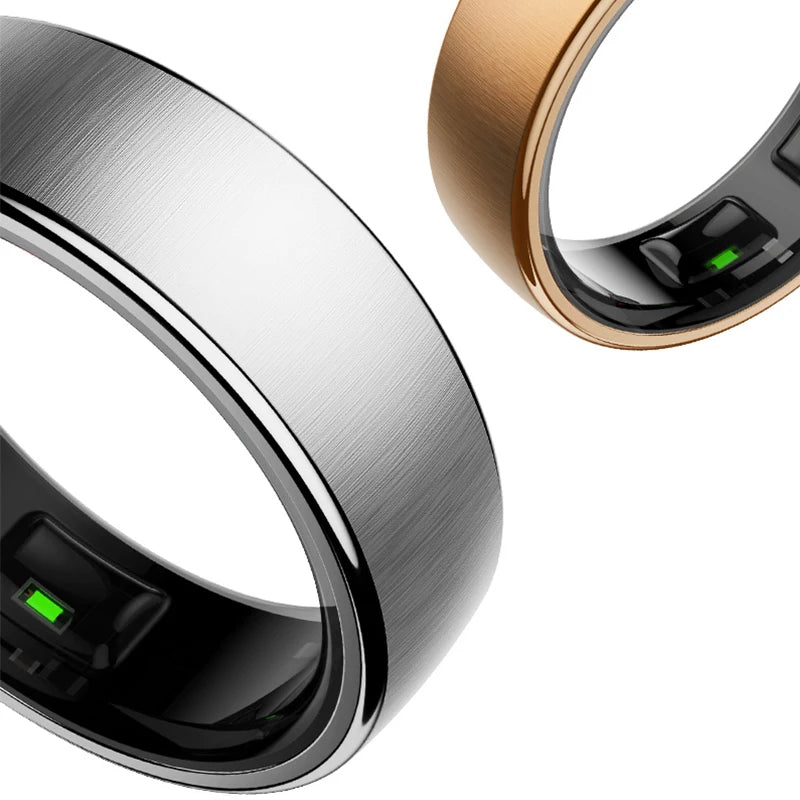 Two sleek, brushed-finish smart health rings in silver and gold, showing internal fitness tracking sensors.