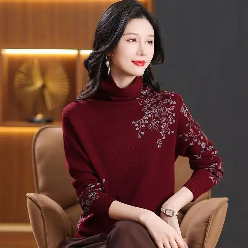 Burgundy high-neck sweater featuring delicate floral embroidery detail on the shoulder and sleeve.
