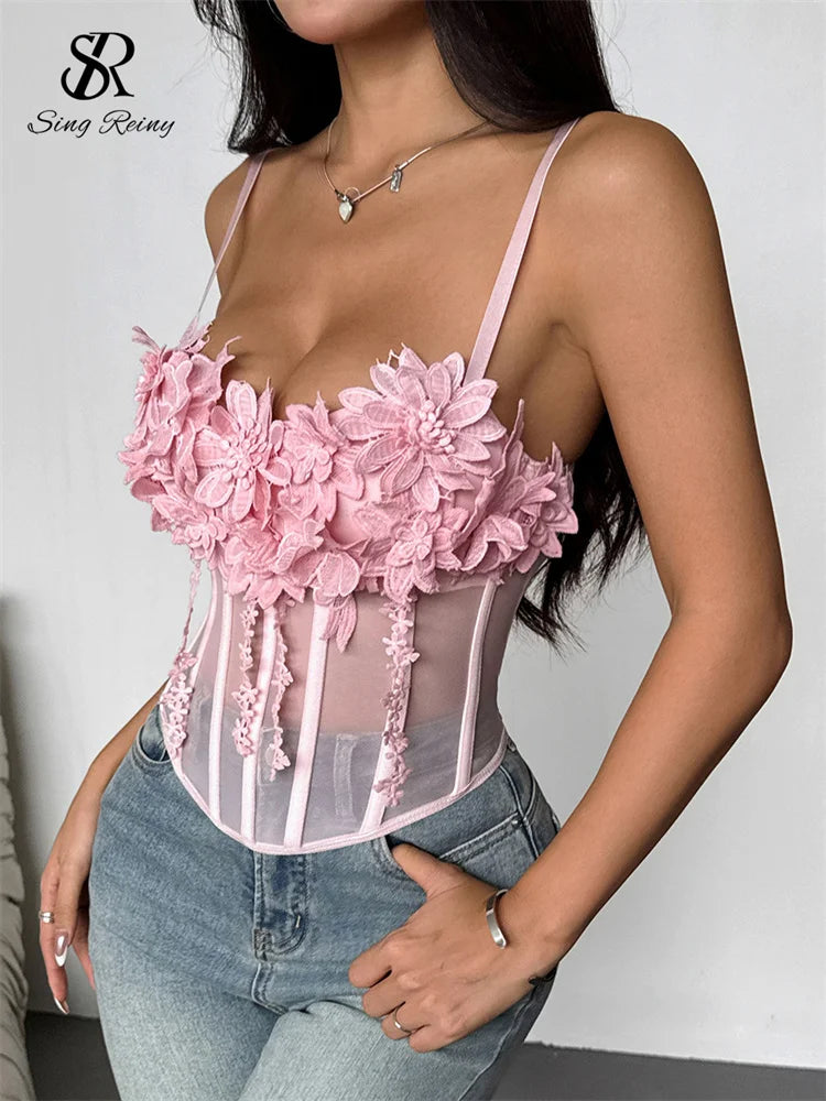 Pink sheer mesh corset top with spaghetti straps, boning, and 3D floral appliqués along the neckline.