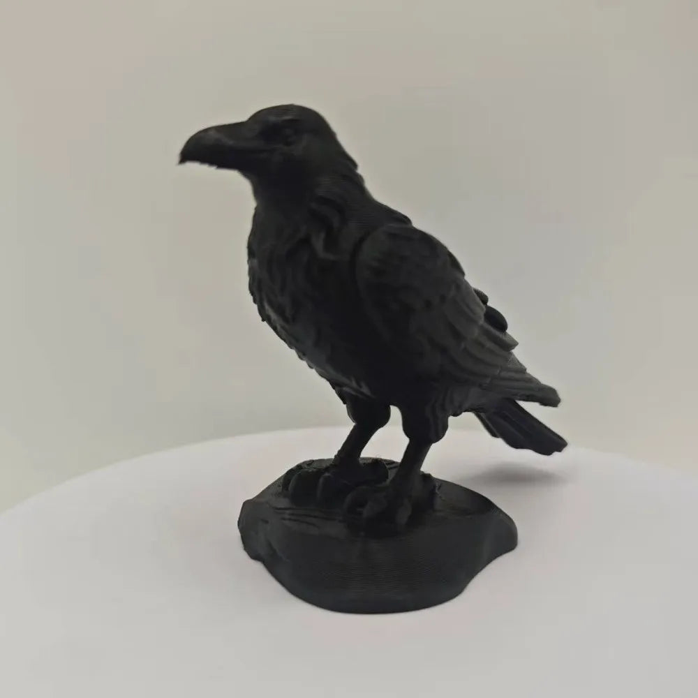 Matte black raven figurine standing on a textured base, featuring detailed feathers and a realistic bird silhouette.