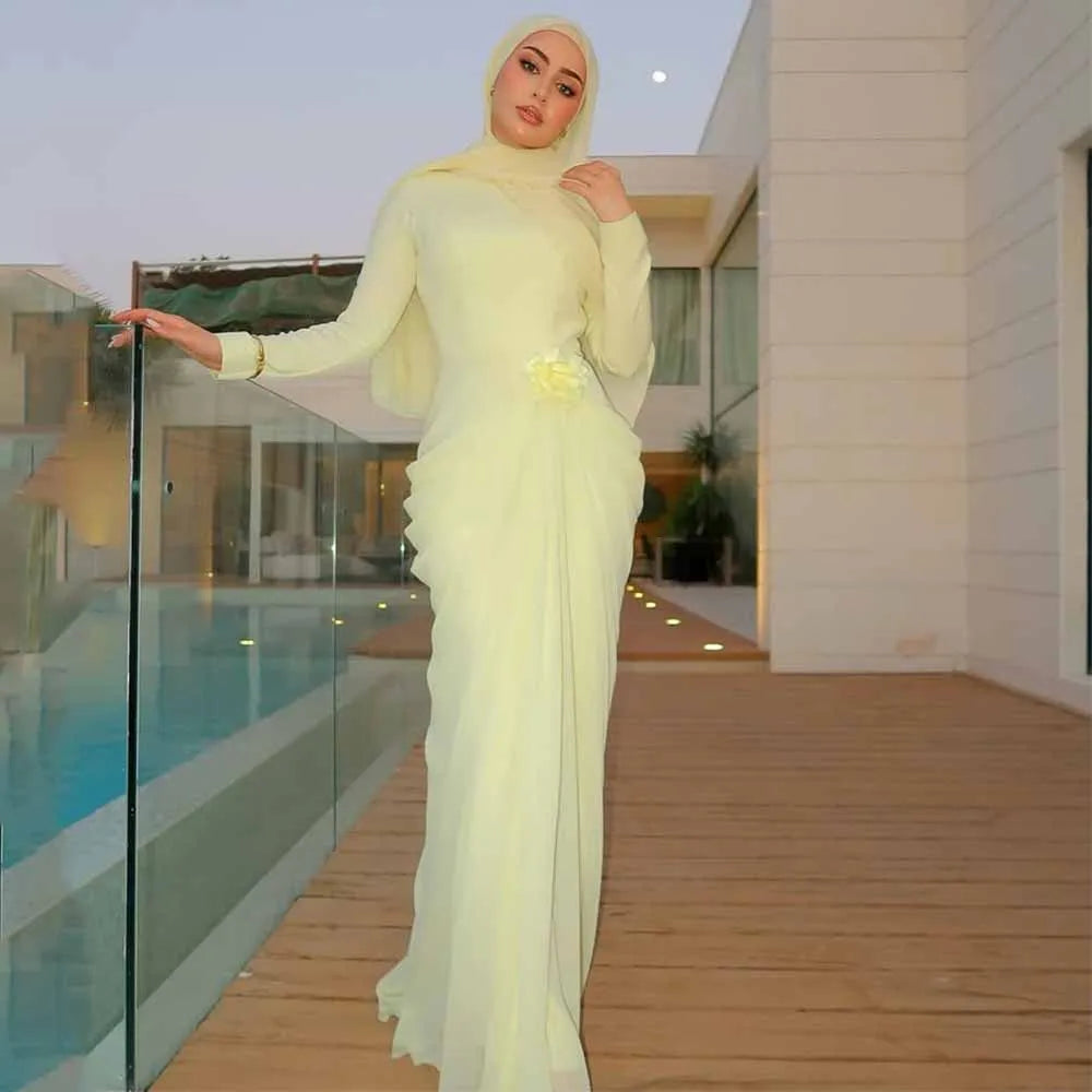 Light yellow long-sleeve high-collar mermaid evening gown featuring 3D flower and pleated waist detail.
