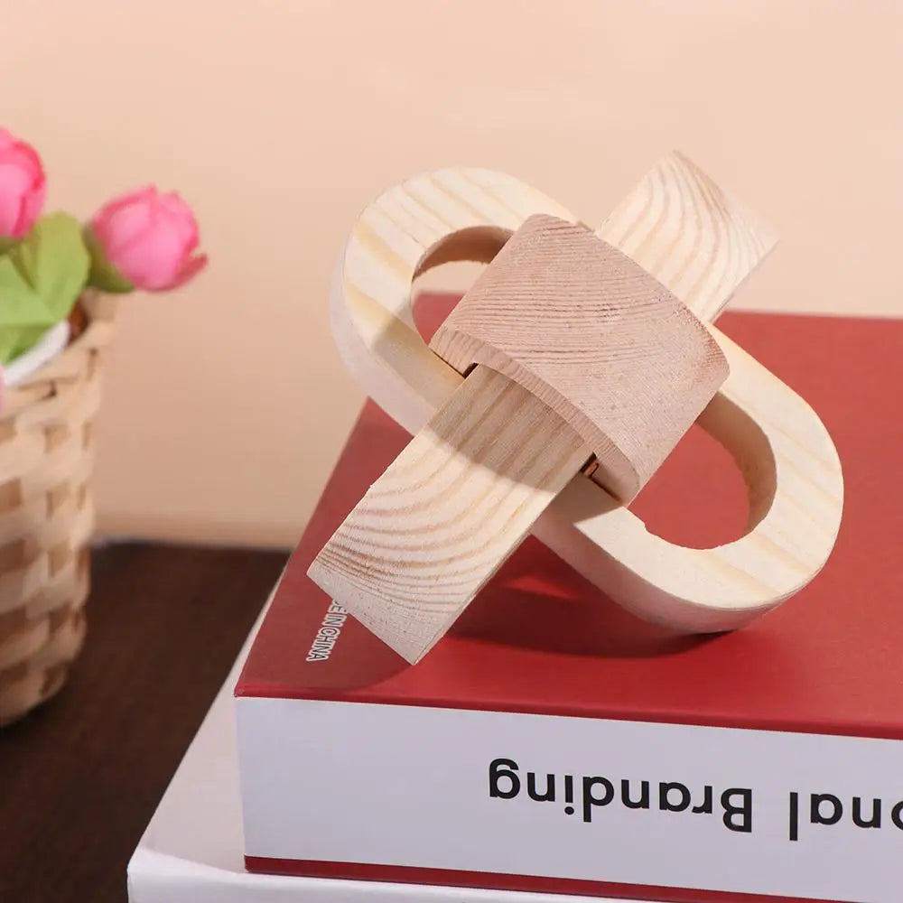 Decorative wooden knot sculpture in light natural pine finish, featuring an interlocking organic shape.