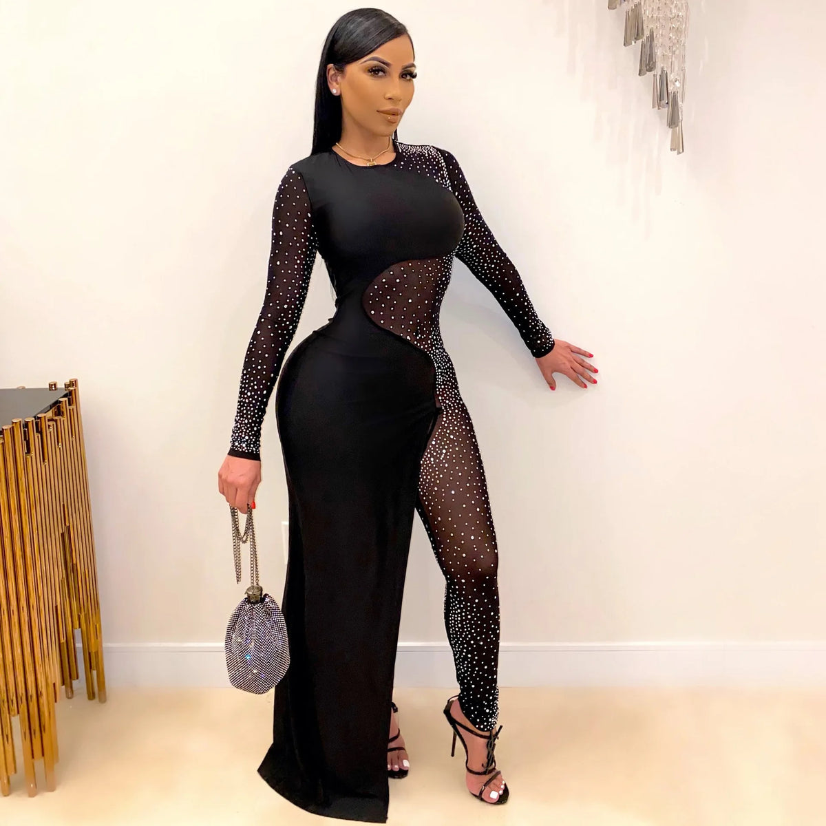 Black long-sleeve skinny jumpsuit with sheer mesh patchwork and sparkling rhinestone embellishments.