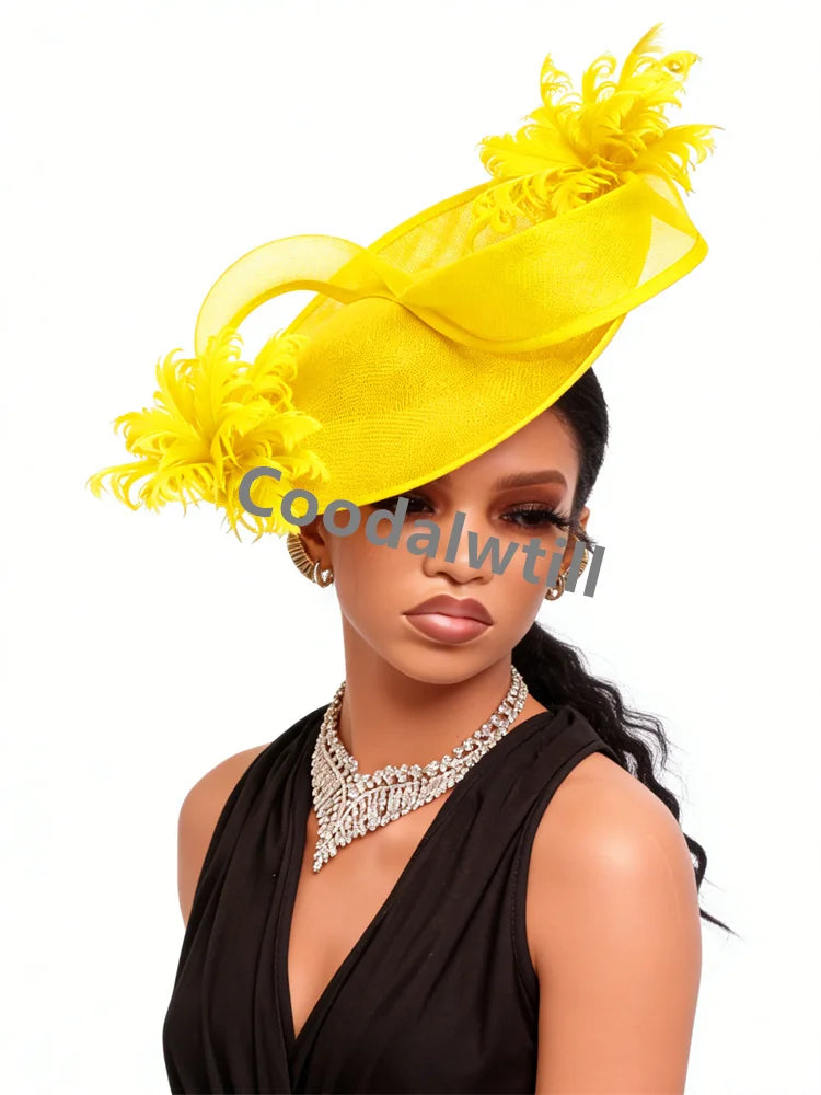 Bright yellow fascinator with curved organza loops and decorative feathers worn by a model in a black dress.
