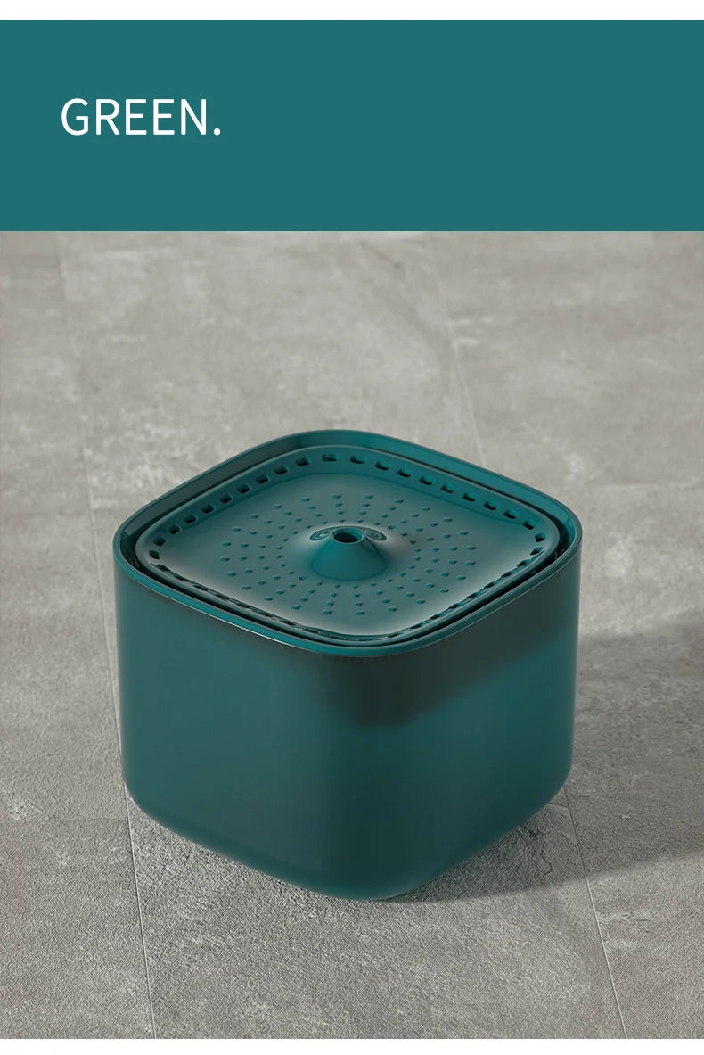 Square dark green pet water fountain with a perforated top surface and central water spout.