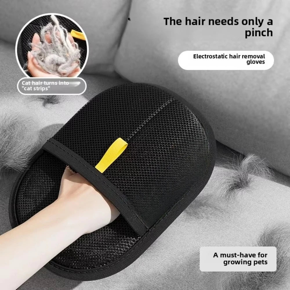 Black electrostatic pet hair removal glove with a yellow fabric tab, shown on a grey fabric surface.