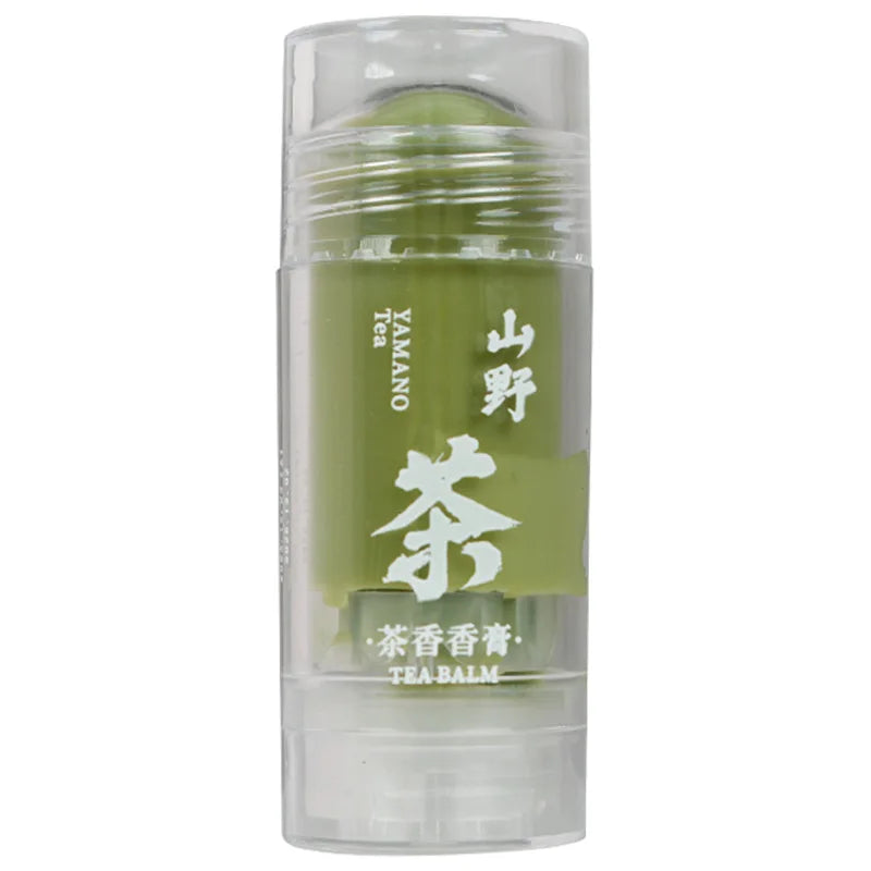 Green tea solid body balm stick in a clear plastic container with white Japanese and English text.