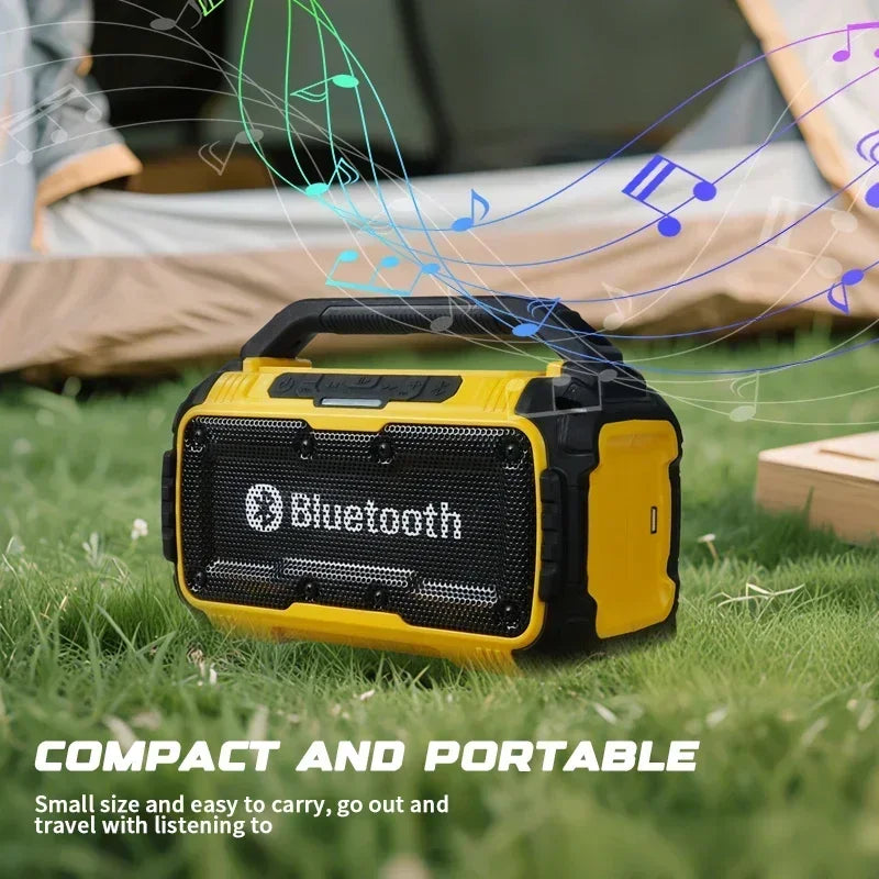 Rugged, yellow and black portable Bluetooth speaker with a carry handle, set on grass in an outdoor camping setting.