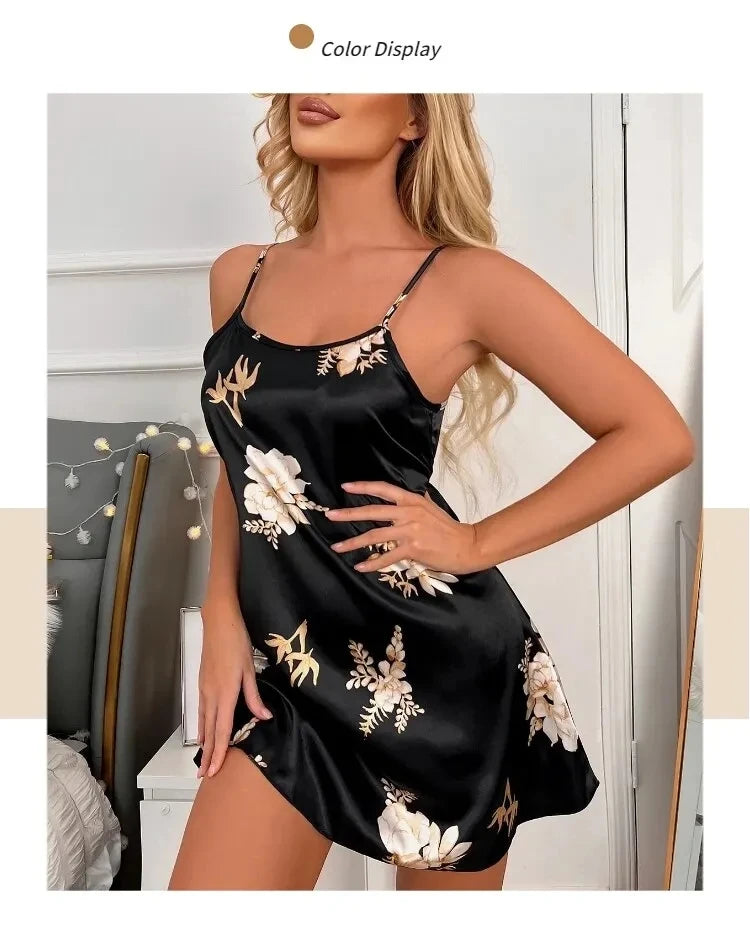Black satin nightdress with delicate floral print, spaghetti straps, and a relaxed, feminine silhouette.