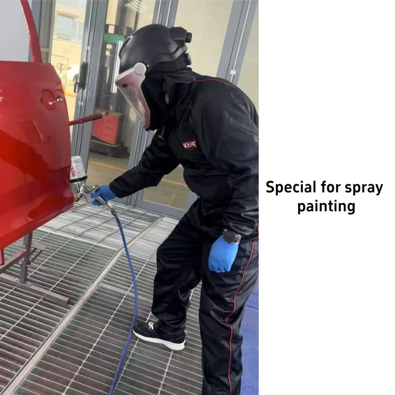 Person wearing black synthetic protective coveralls, a full-face safety mask, and blue gloves spray painting a car.